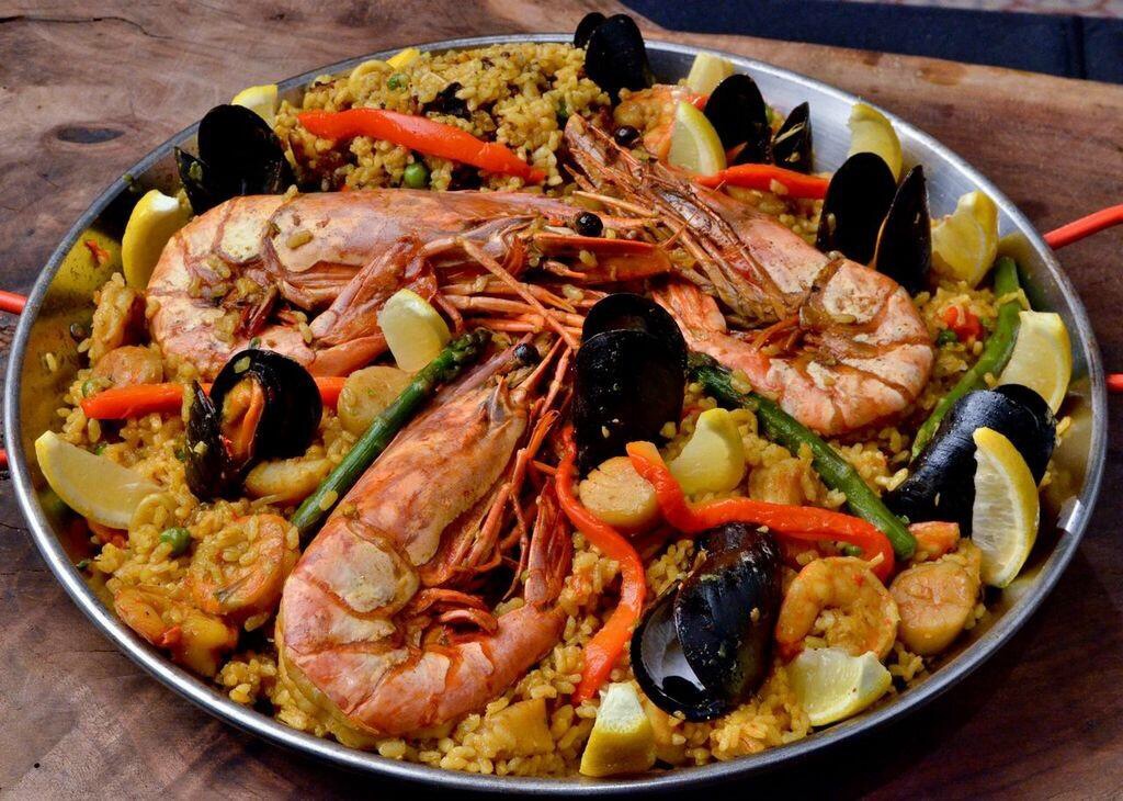 Seafood paella with prawns, mussels and lemon prepared by Chef Eric Paz